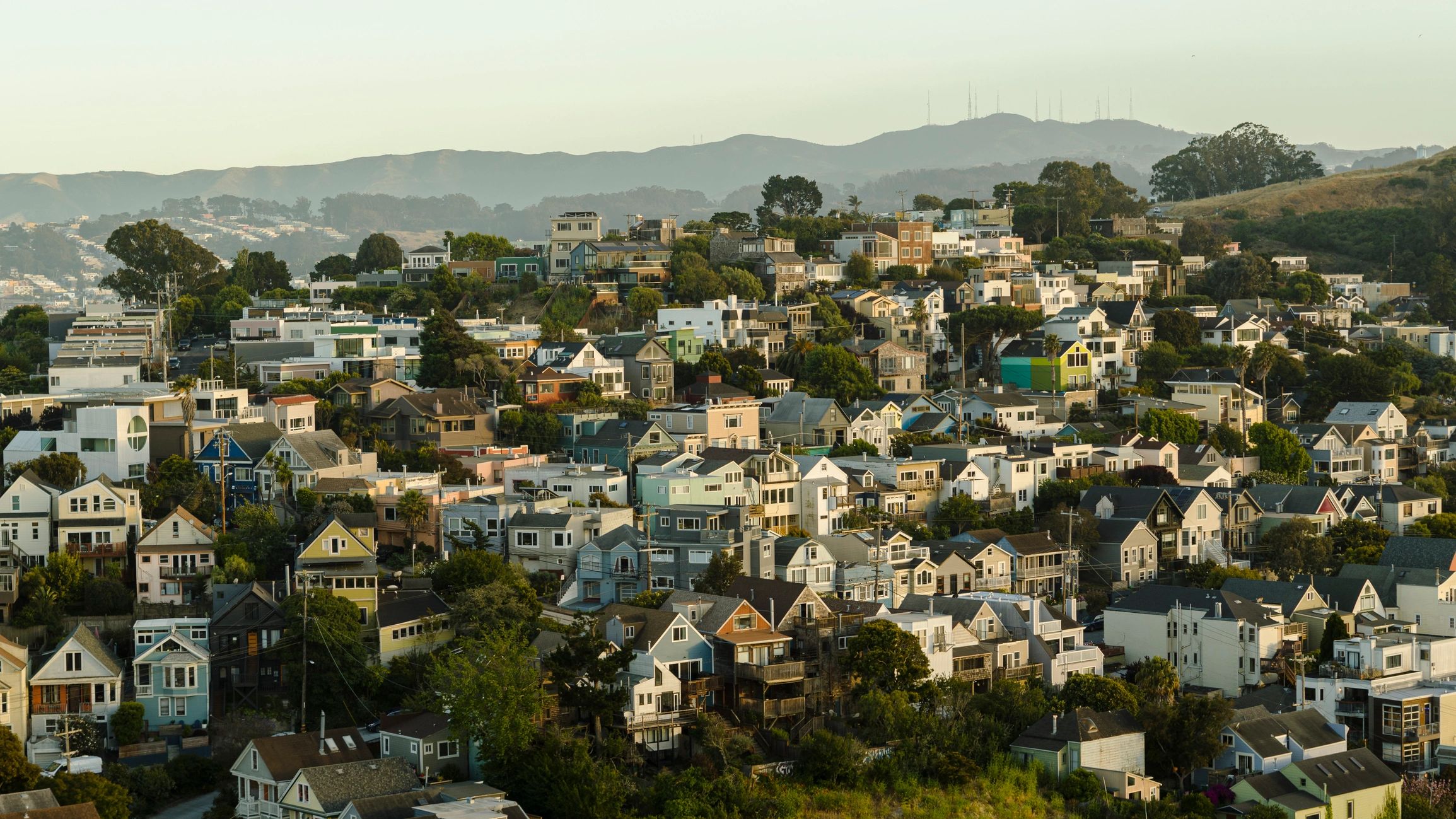 Bay Area hillside neighborhood with a wide view of homes